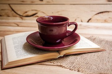 cup with orange flowers on a wooden background