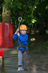 Obraz premium boy climbing a rope park, Girl climbing in adventure park 