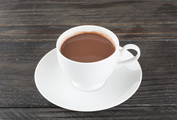 a cup of chocolate on wood table