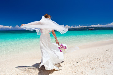 Fototapeta na wymiar Happy dancing bride on beach