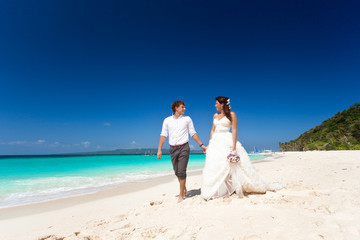 Bride and groom  having fun on beach