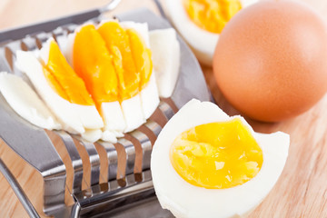 Egg cutter and cutted eggs on table
