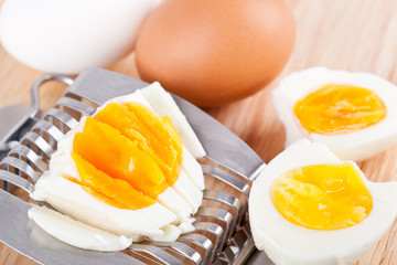 Egg cutter and cutted eggs on table