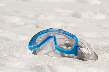 Swimming mask on white sand