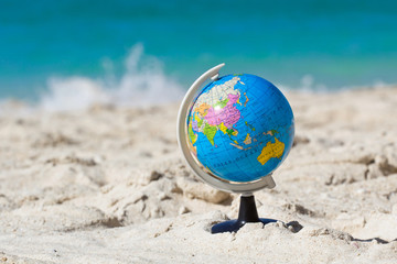 Globe on tropical beach