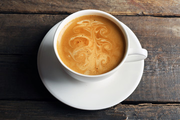 Cup of coffee latte art on wooden table, closeup