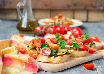Bruschetta with zucchini, bacon, green onions and cherry tomatoe