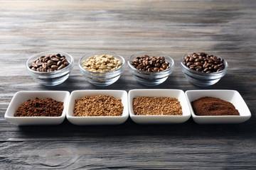 Coffee beans in saucers on wooden background