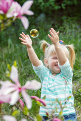 Girl pops the bubbles and has fun
