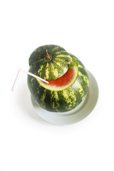 fresh green watermelon with cocktail straw and mint leaves isolated on white background