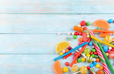 Colorful candies on wooden background