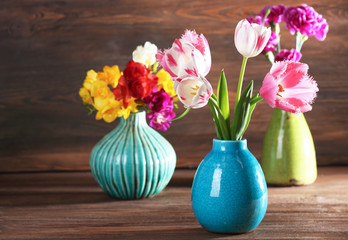 Beautiful fresh spring flowers on wooden background