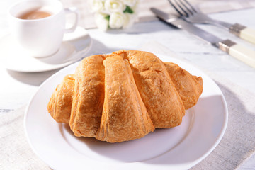 Delicious croissants on plate on table close-up