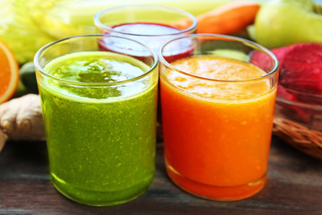 Assortment of healthy fresh juices on wooden table background