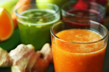 Assortment of healthy fresh juices on wooden table background