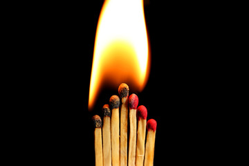 Burning matches on dark background