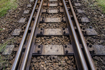 railroad tracks with railroad switch, two paths come together