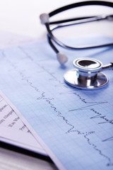 Cardiogram with stethoscope on table, closeup