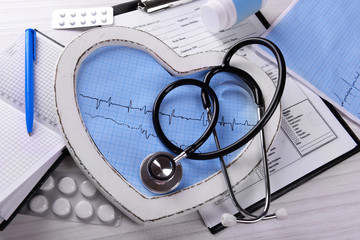 Cardiogram with stethoscope on table, closeup