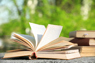 Stack of books outdoors, on blurred background
