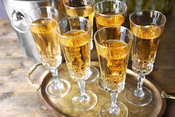 Glasses of champagne on bright background