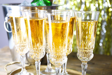 Glasses of champagne on bright background