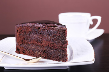 Piece of chocolate cake on white plate, closeup