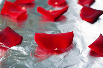 Roses petals on foil, close-up. Candied flowers concept