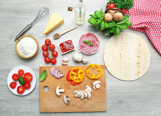 Food ingredients for pizza on table close up