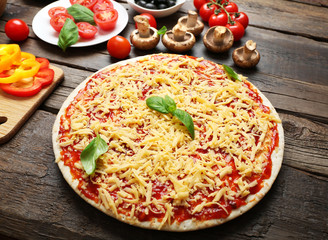 Food ingredients for pizza on table close up