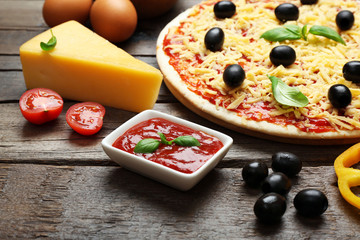 Food ingredients for pizza on table close up