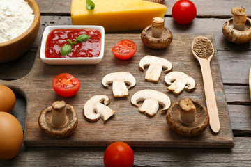 Food ingredients for pizza on table close up