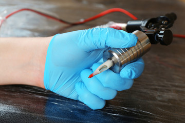 Tattoo artist at work close up