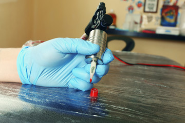 Tattoo artist at work close up