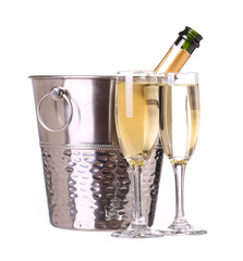 Champagne bottle in bucket with ice and glasses of champagne, is