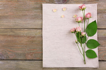 Beautiful dry flowers on napkin on wooden background