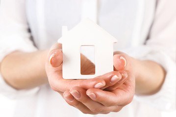 Woman holding model of house close up