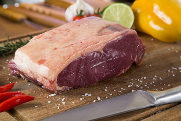 Organic Red Raw Steak Sirloin on wooden board