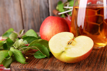 Glass of apple juice on wooden background