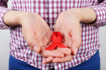 Female hands with color ribbon, closeup