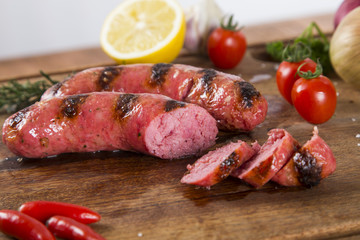grilled meat sausages with potatoes and tomatoes