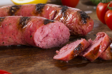 grilled meat sausages with potatoes and tomatoes