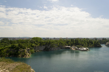 Limestone quarry lake with deep blue water and steep walls
