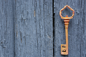 Old key on wooden antique door close-up