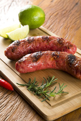 grilled meat sausages with potatoes and tomatoes