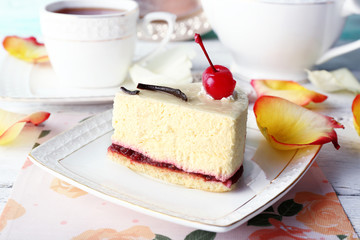 Tasty piece of cheesecake on plate on table close up