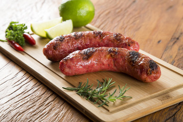 grilled meat sausages with potatoes and tomatoes