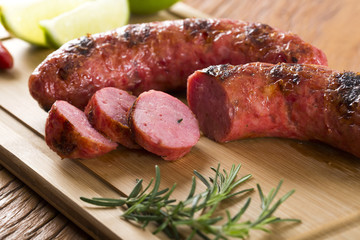 grilled meat sausages with potatoes and tomatoes
