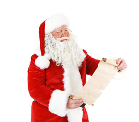 Santa Claus holding wish list, isolated on white background