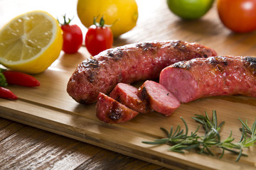 grilled meat sausages with potatoes and tomatoes